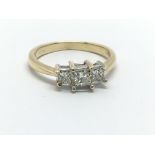 An 18ct gold ring set with three princess cut diam