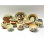 A collection of various Clarice Cliff ceramics including plates, jugs and pots