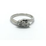 A platinum three stone diamond ring, approx 5.4g and approx size M.