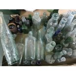 A large collection of vintage glass bottles some with stoppers.