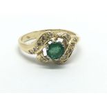 An 18ct gold emerald and diamond cluster ring, app