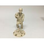 A late 19th century ivory carving of an elder on a rustic base signed height 16cm