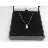 A 9ct white gold solitaire diamond pendant on a wh