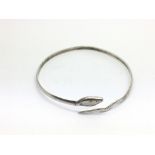 A silver snake bangle.