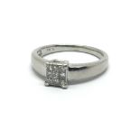 A platinum nine stone diamond ring set with princess cut diamonds, approx 5g and approx size O.