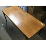 A modern design teak and polished elm table with a rectangular top.
