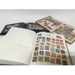 Two stamp albums containing world stamps and a postcard album containing British and Irish landscape