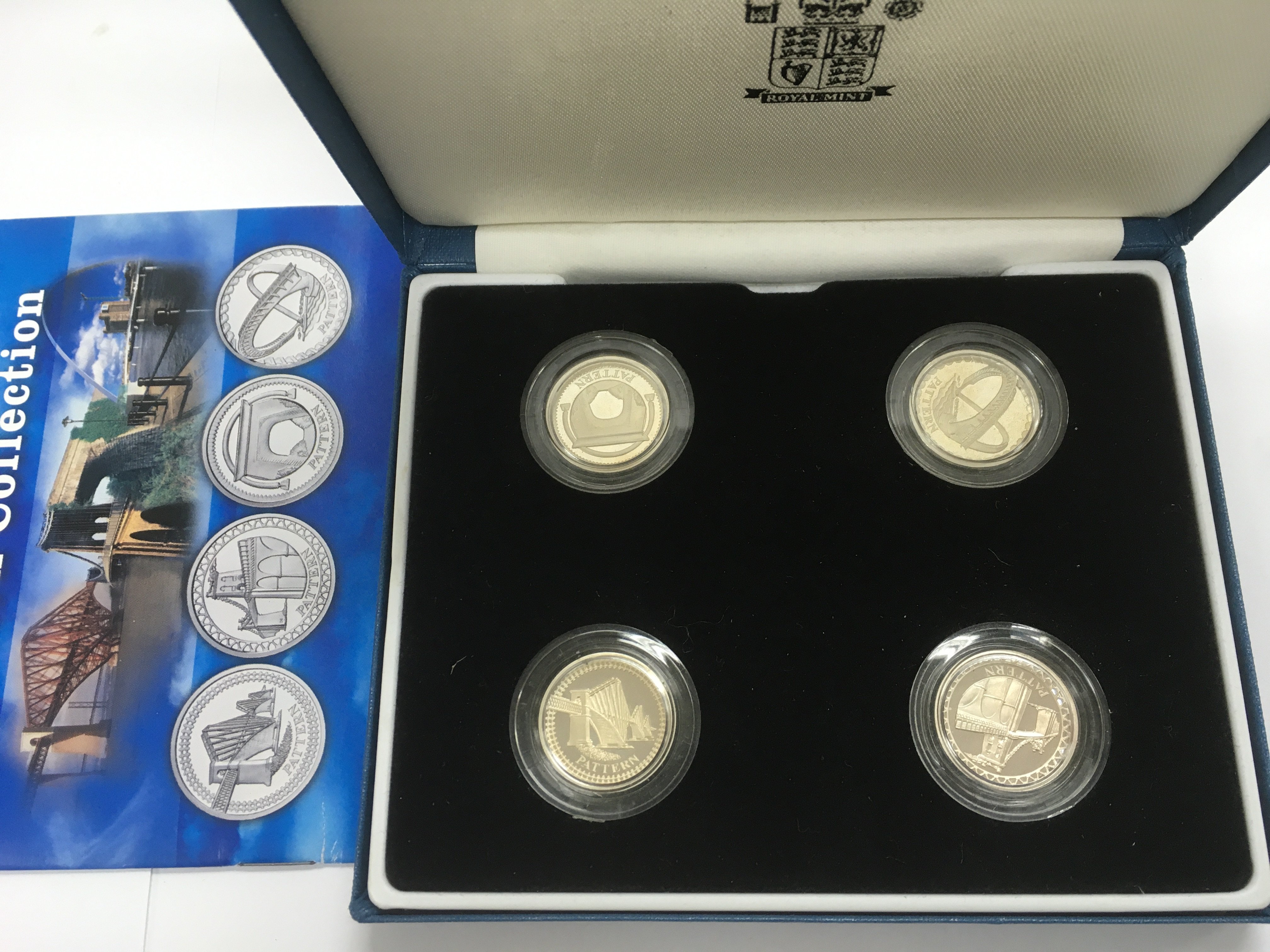 A boxed set of four silver proof pattern collection coins.