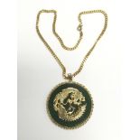An Oriental jade pendant on a chain and decorated