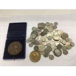 An unusual medallion and a collection of various coins.