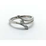 A 9ct white gold three stone diamond ring, approx .12ct, approx size K.