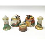 A collection of Clarice Cliff ceramics including two Fantasque beehive pots and a cruet set