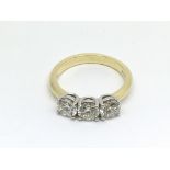 An 18ct gold three stone diamond ring, RBC diamond