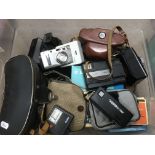 A box of cameras and a cased pair of binoculars.