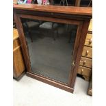 A Edwardian mahogany display cabinet fitted with with three selfs and having a single glazed