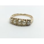 An 18ct gold ring set with five pearls, approx 3.5