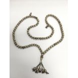 A white metal patterned ball necklace.