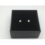 A pair of boxed 18ct white gold diamond studs. Dia