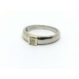 An 18ct white gold ring set with four small prince