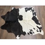 A cow skin rug of cream and brown