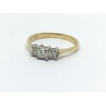 An 18ct gold diamond ring set with three princess