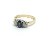 A gold ring set with a central Ceylon sapphire and