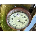 A small stained oak framed wall clock (no pendulum