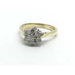 An 18ct gold seven stone diamond cluster ring in t