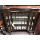 A walnut display cabinet with a glazed door on cab