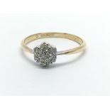 An 18ct gold and platinum seven stone diamond ring in the form of a flowerhead, approx 2.5g and