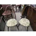 An Ercol drop leaf dining table and a set of six chairs dark wood finish.