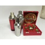 Three cocktail shakers and a miniature Middle Eastern brass presentation set.