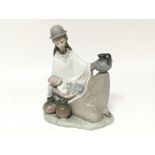 A Lladro figure of a young woman cradling a child and with various pots. No damage