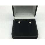 A pair of 18ct gold diamond studs, approx 25 point