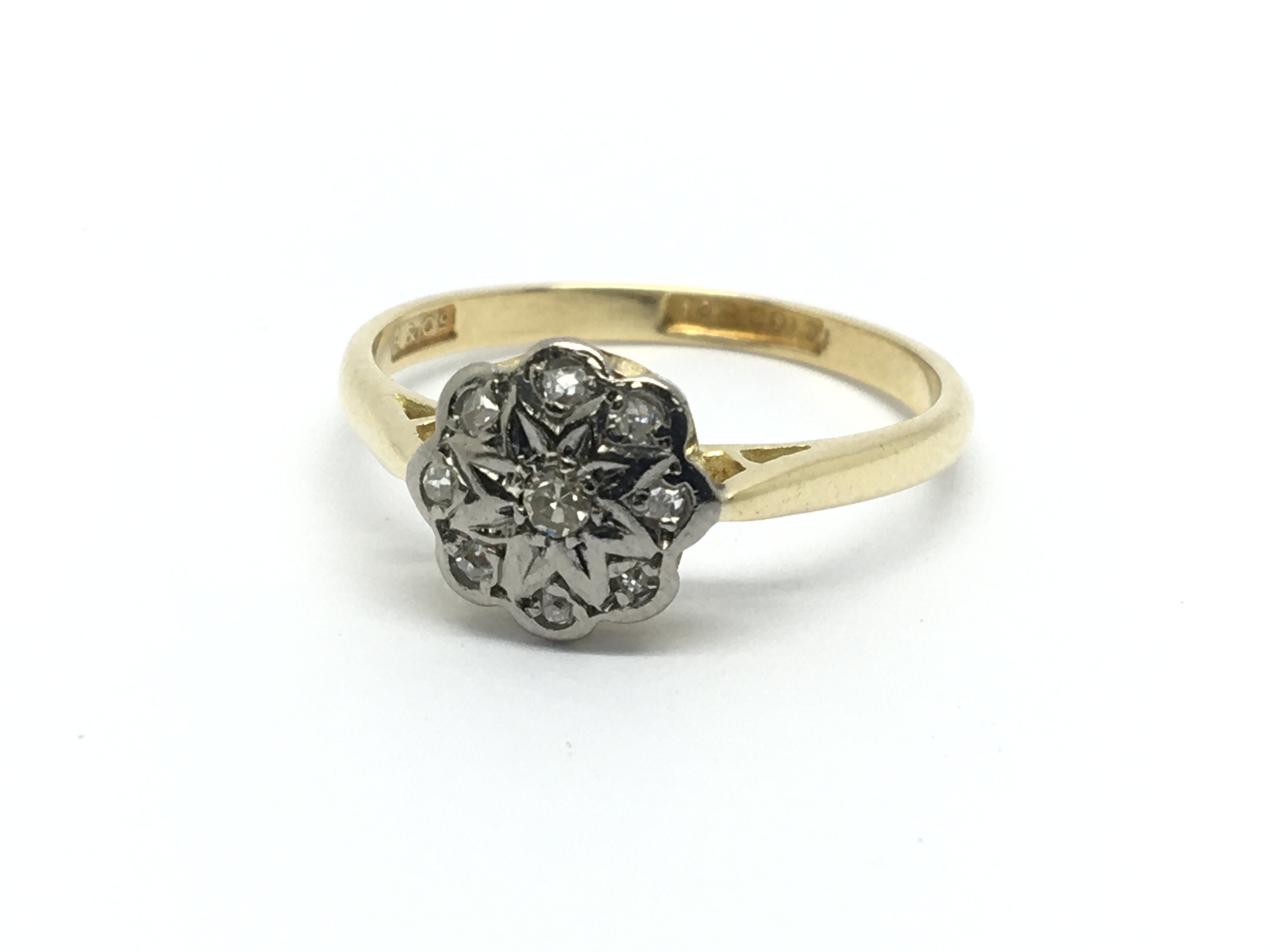 A 1930s 18ct gold ring set with diamonds in the fo
