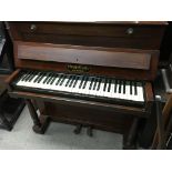 A small walnut cased Chappell & Co upright piano with wooden frame