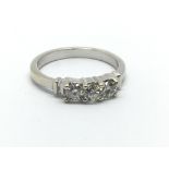 An unmarked white gold three stone diamond ring, approx 3.4g and approx size L.