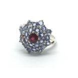 A 9ct white gold ruby and possibly topaz cluster r