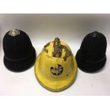 Vintage fireman’s helmet and two vintage police helmets