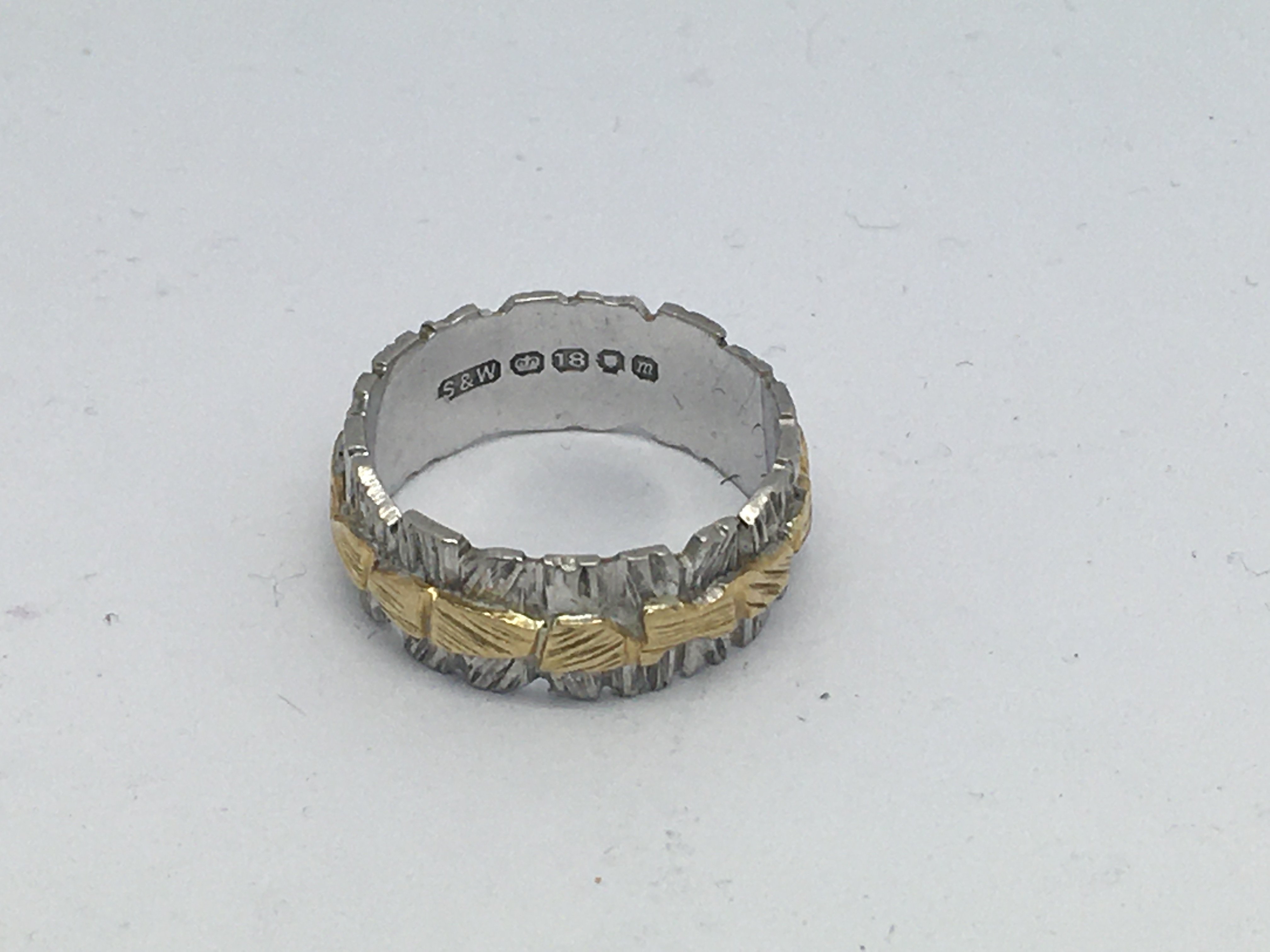 An 18ct yellow and white gold band, 5.3g, (J).