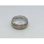 An 18ct yellow and white gold band, 5.3g, (J).