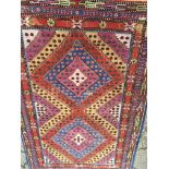 A hand knotted rug with a two diamond centre field and repeat pattern boarder 235x150