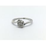 An unmarked white gold seven stone diamond ring, a