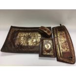 A leather desk set with giltwork decoration of anc