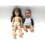 A porcelain doll marked Jayco, England plus another wooden doll with porcelain head marked A.G.M.