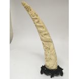 A Quality late 19th century carved ivory tusk with a dragon on a carved hardwood base height 31cm