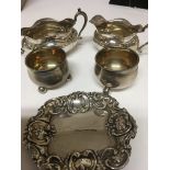 A pair of silver salt callers a silver cream jug and sugar bowl with Chester hallmarks.