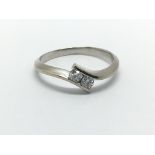 A white gold two stone diamond ring, approx .25ct, approx 3g and approx size P.