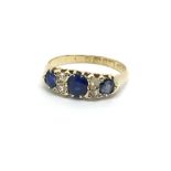 A vintage 18ct gold three sapphire and diamond rin