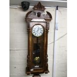 A walnut cased Vienna wall clock with an enamel di